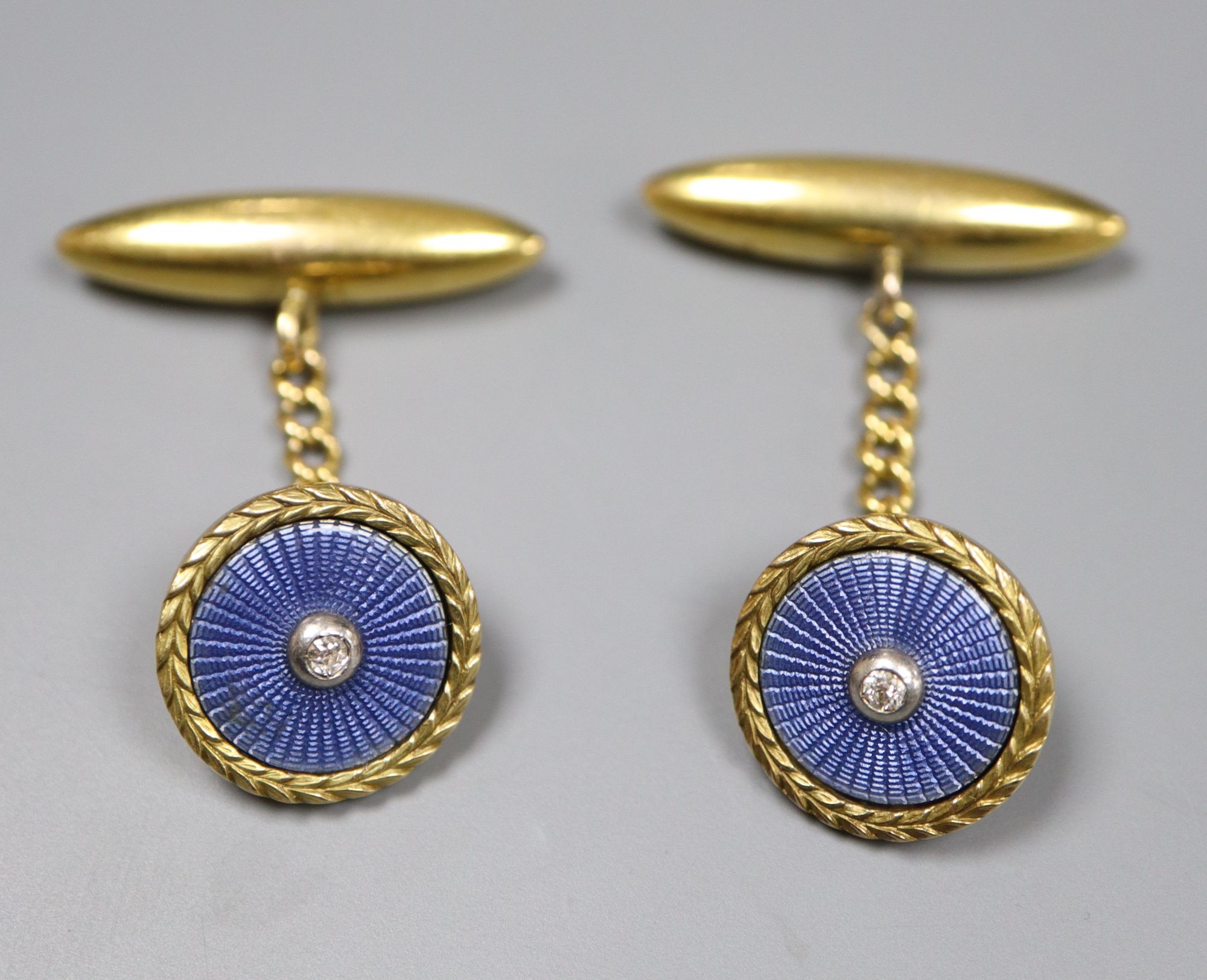 A pair of early-mid 20th century French? yellow metal, guilloche enamel and diamond set circular cufflinks,